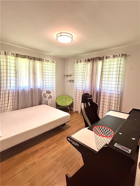 4030 Stonewall Tell Road Atlanta, GA 30349 - Photo 17 of 23 a bedroom with a bed and large windows