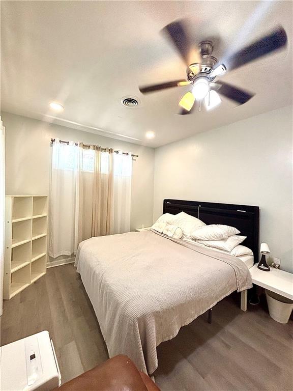 4030 Stonewall Tell Road Atlanta, GA 30349 - Photo 2 of 23 a bedroom with a bed and a chandelier