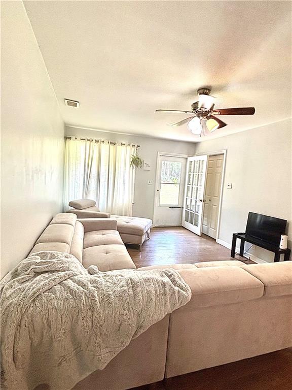 4030 Stonewall Tell Road Atlanta, GA 30349 - Photo 3 of 23 a bedroom with a large bed and a chandelier