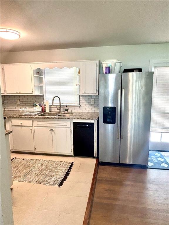 4030 Stonewall Tell Road Atlanta, GA 30349 - Photo 4 of 23 a kitchen with stainless steel appliances granite countertop a refrigerator a sink and a stove