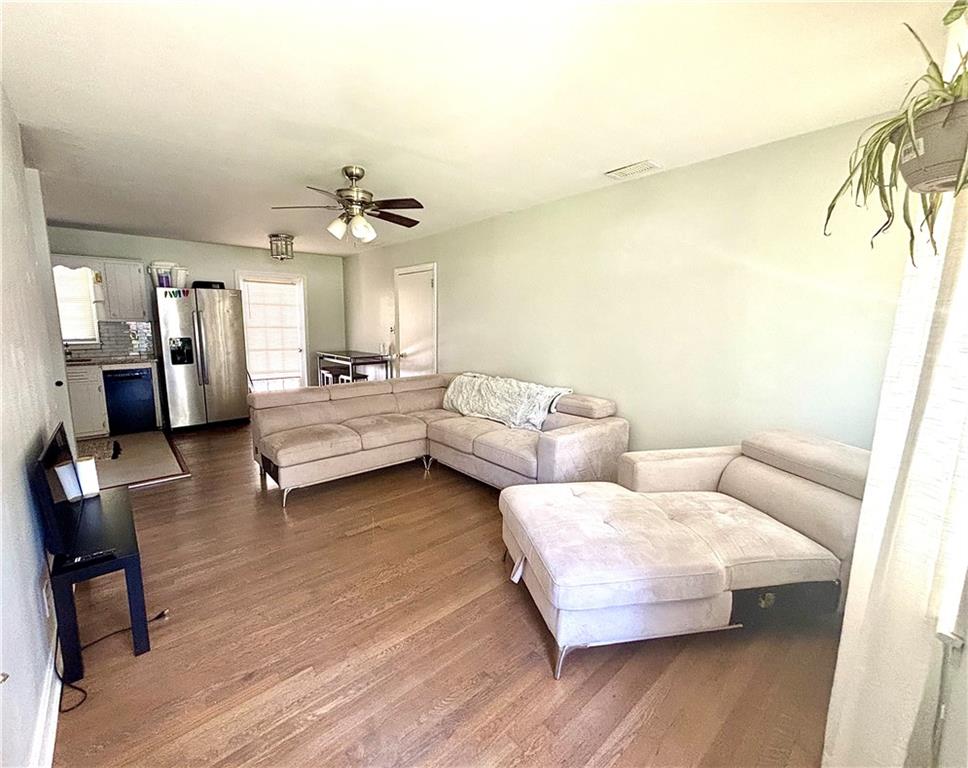 4030 Stonewall Tell Road Atlanta, GA 30349 - Photo 5 of 23 a living room with furniture and a chandelier