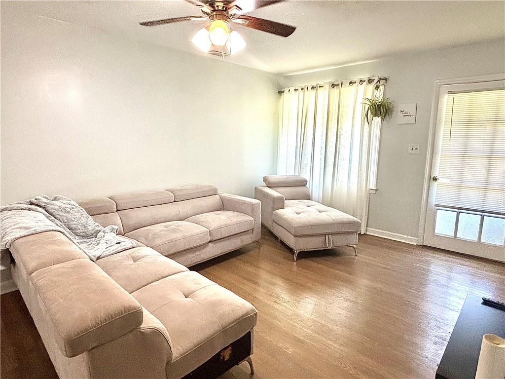 4030 Stonewall Tell Road Atlanta, GA 30349 - Photo 6 of 23 a living room with furniture and wooden floor