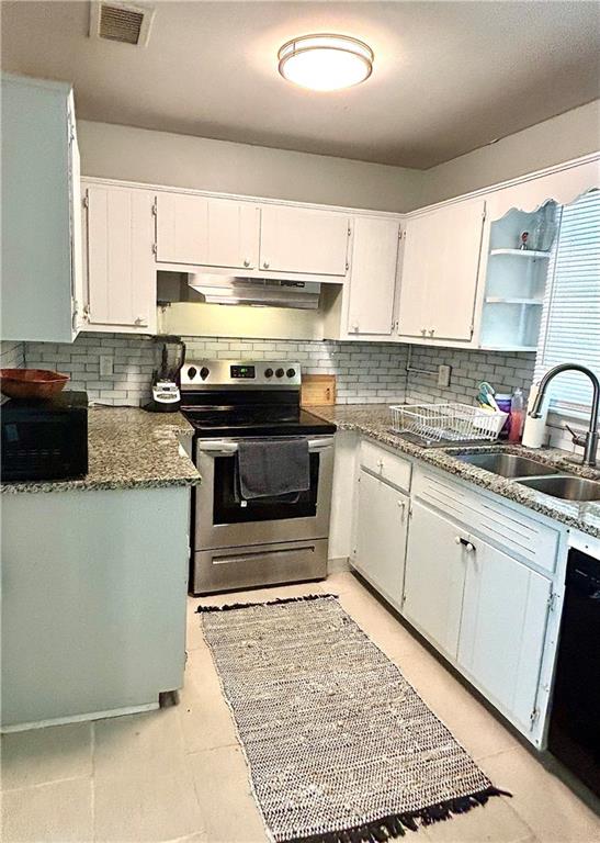 4030 Stonewall Tell Road Atlanta, GA 30349 - Photo 8 of 23 a kitchen with stainless steel appliances granite countertop a stove a sink and a microwave
