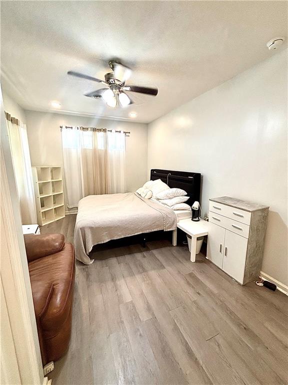 4030 Stonewall Tell Road Atlanta, GA 30349 - Photo 9 of 23 a bedroom with a bed and wooden floor