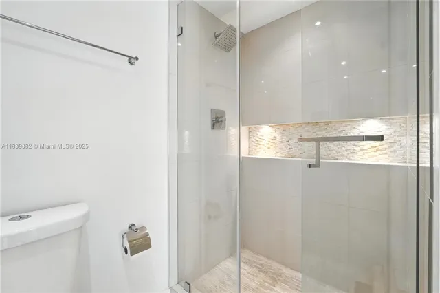 a bathroom with a shower and a toilet