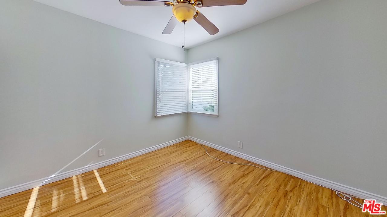 2027 Euclid Street, Unit E Santa Monica, CA 90405 - Photo 16 of 18 a view of an empty room with window and wooden floor