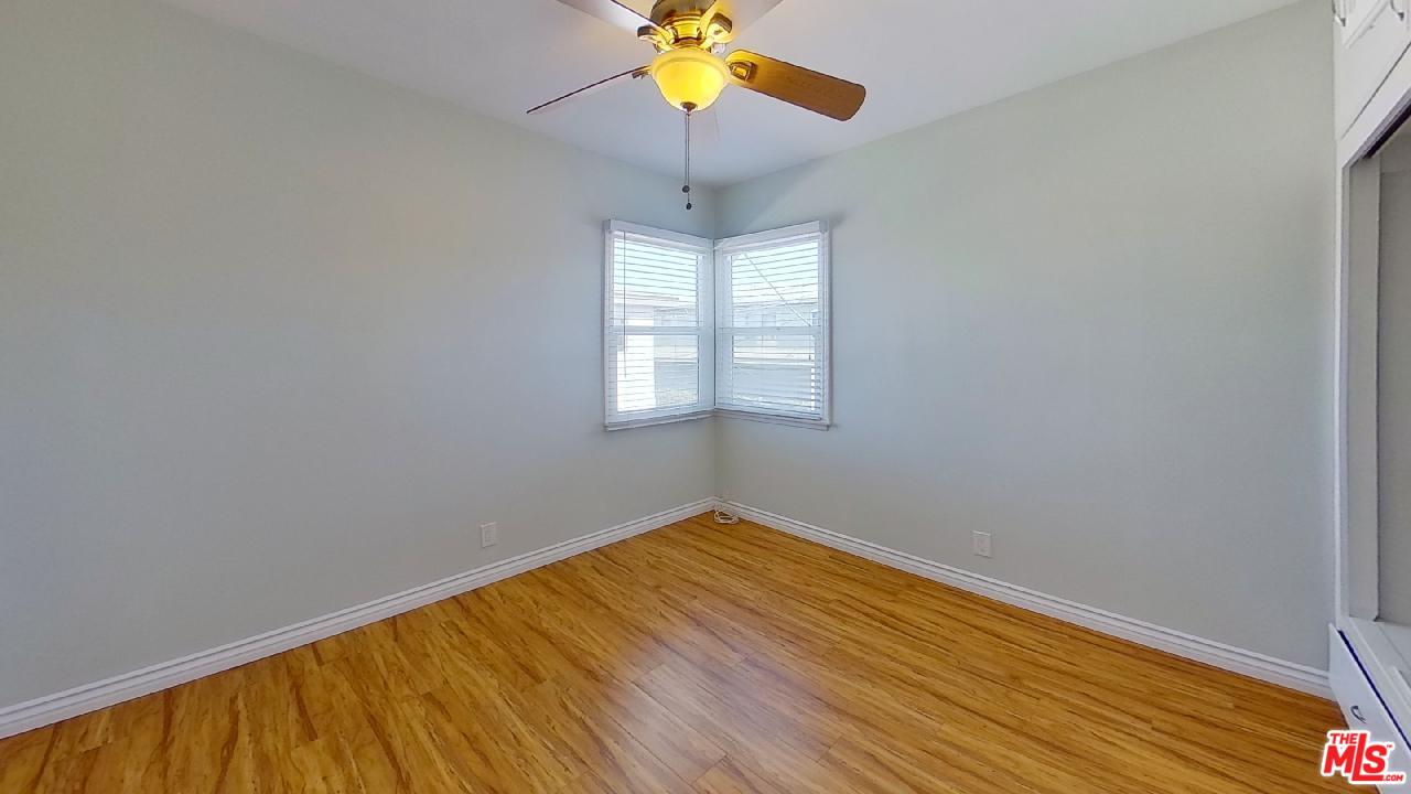 2027 Euclid Street, Unit E Santa Monica, CA 90405 - Photo 17 of 18 a view of empty room with window and chandelier fan