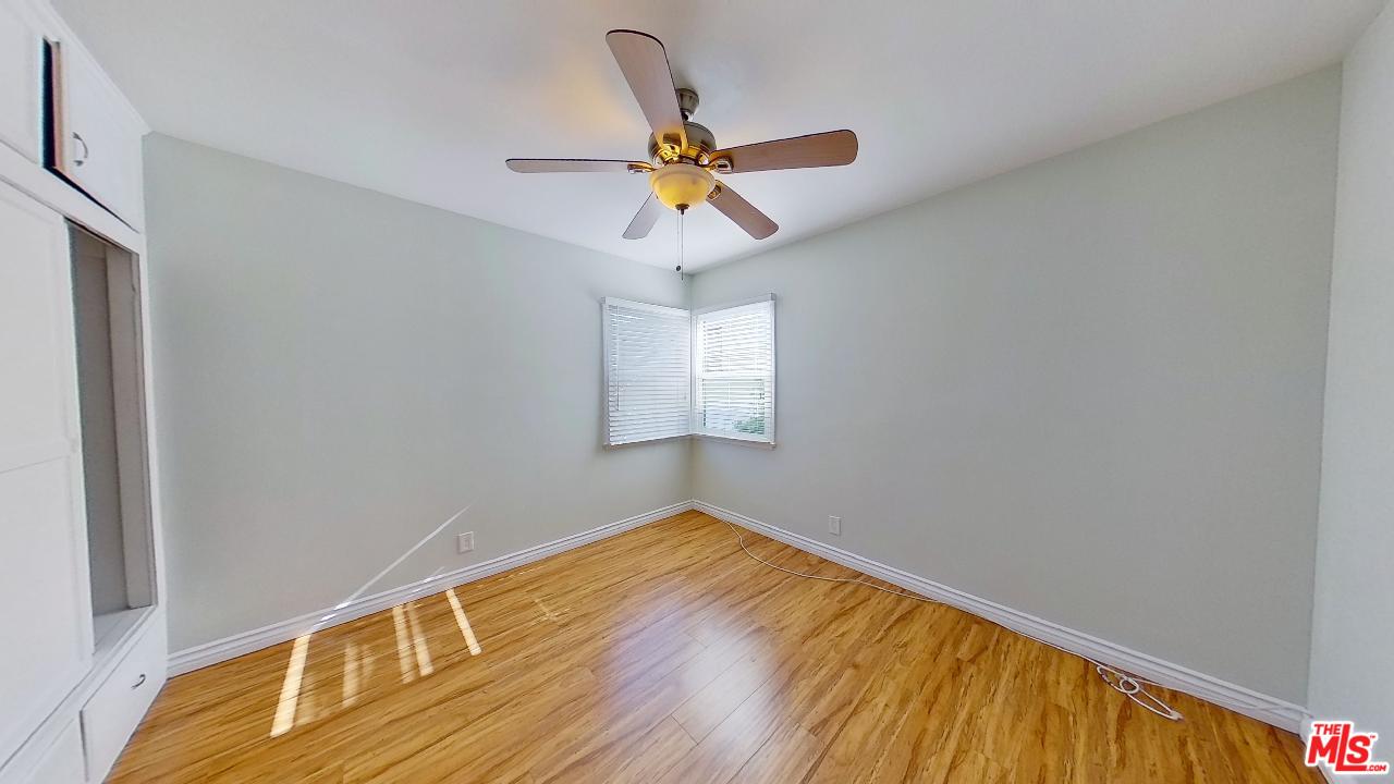 2027 Euclid Street, Unit E Santa Monica, CA 90405 - Photo 10 of 18 a view of empty room with wooden floor and ceiling fan