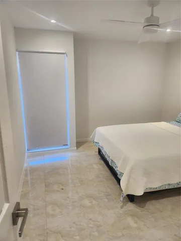 a bedroom with a bed and a shower
