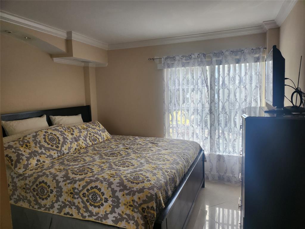 4160 Inverrary Drive, Unit 311 Lauderhill, FL 33319 - Photo 5 of 15 a bedroom with a bed and a window
