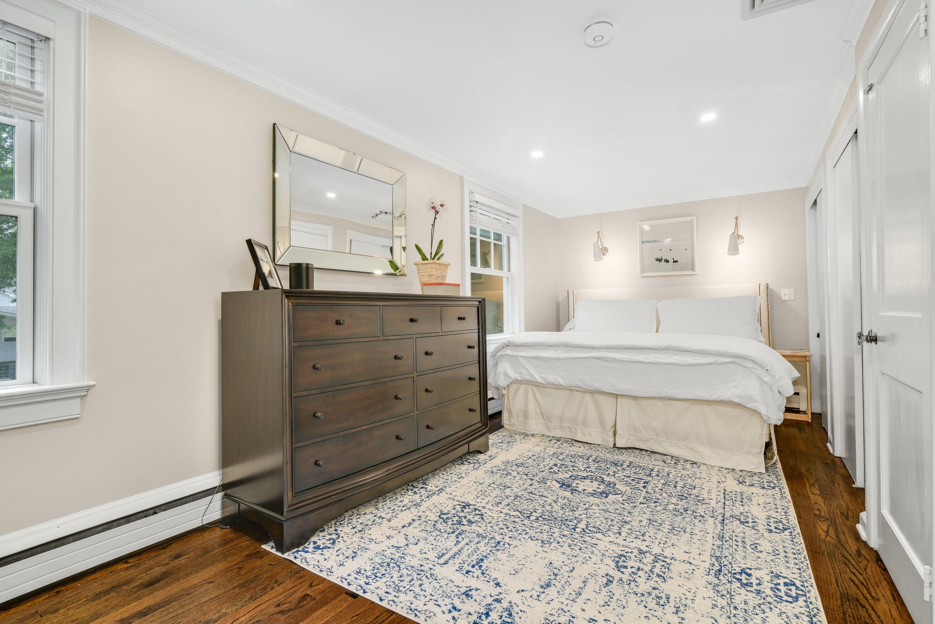 13 Sunset Road Darien, CT 06820 - Photo 15 of 28 a bedroom with a bed and wooden floor