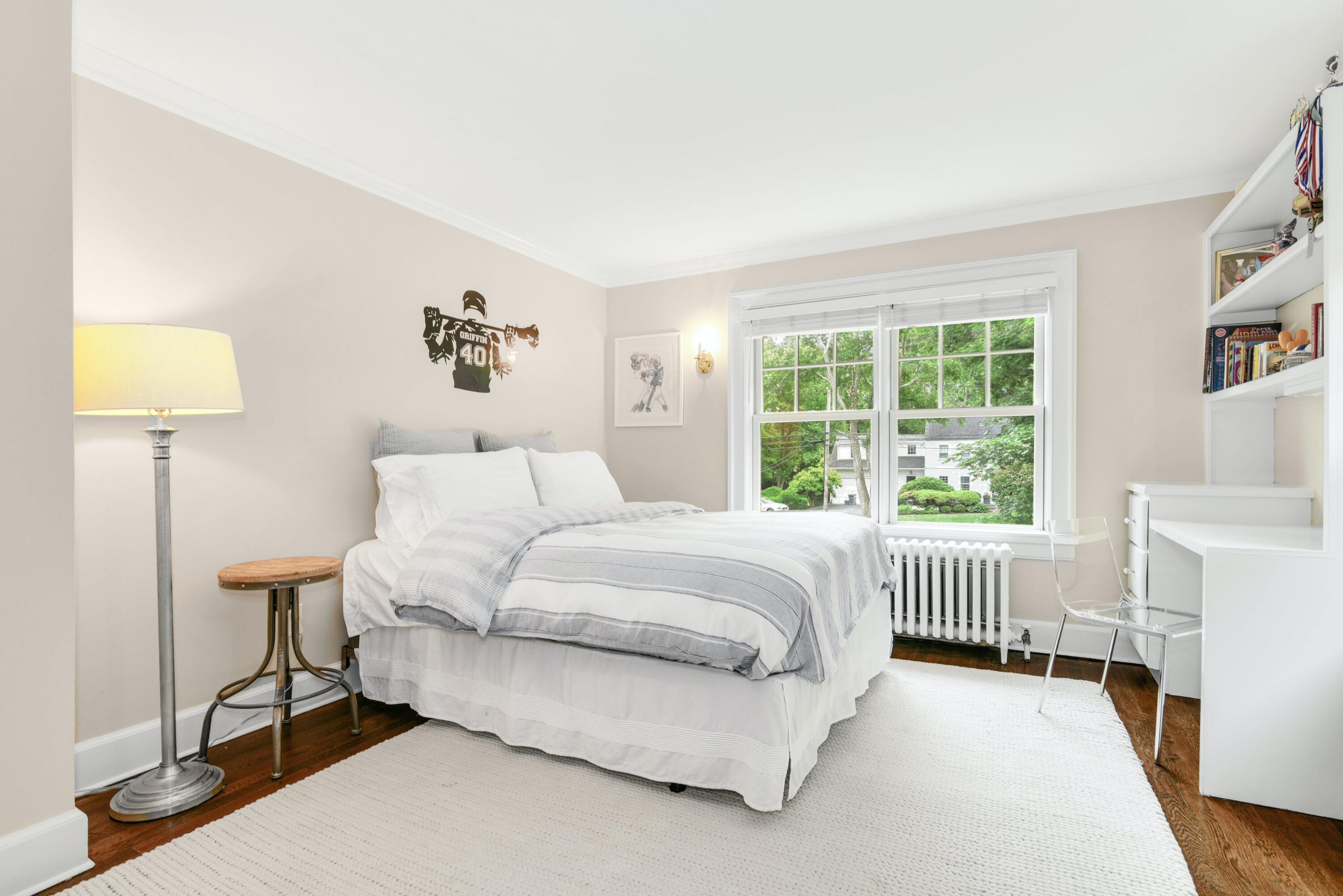 13 Sunset Road Darien, CT 06820 - Photo 18 of 28 a bedroom with a bed and a lamp