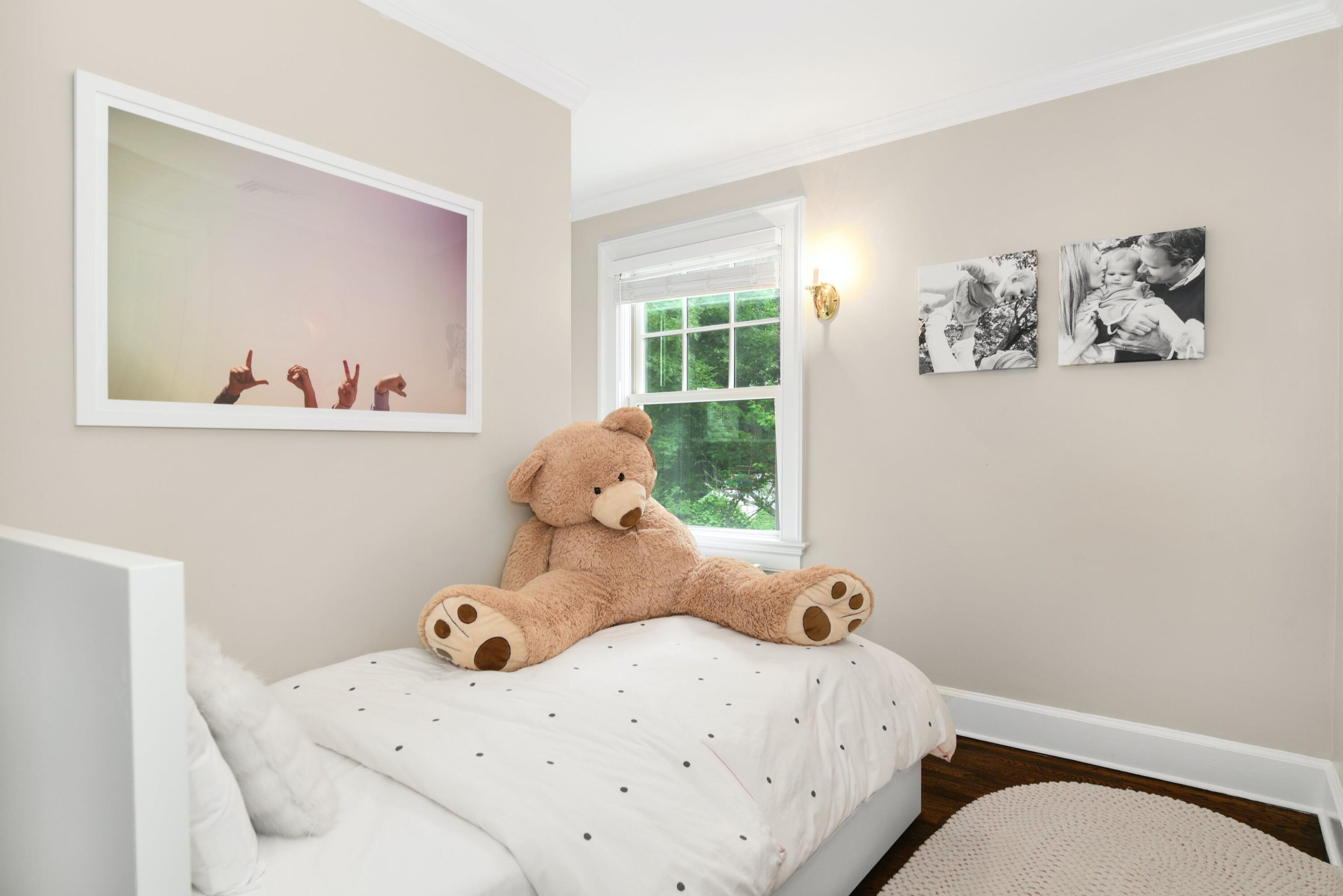 13 Sunset Road Darien, CT 06820 - Photo 20 of 28 a bedroom with a bed and wooden floor