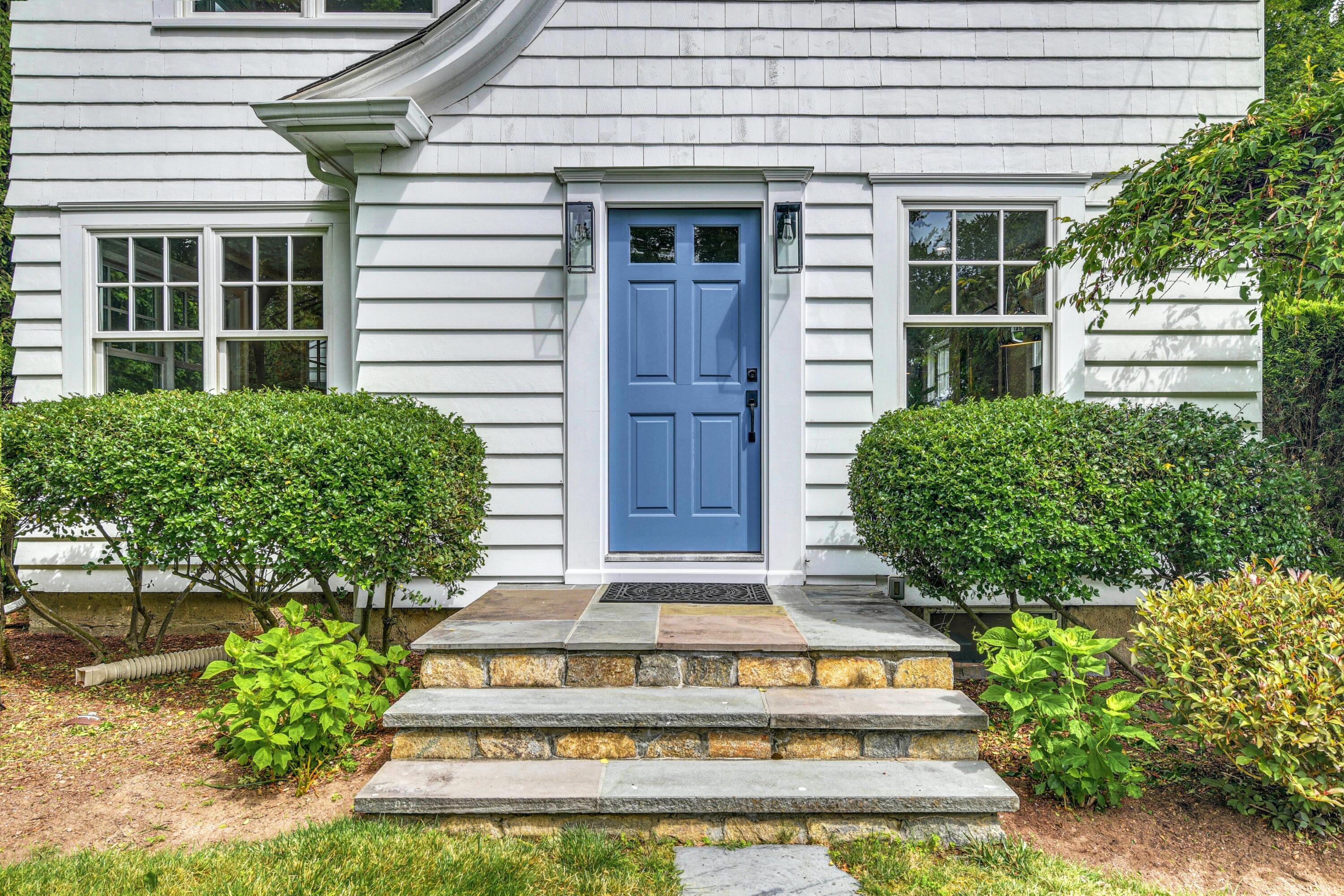 13 Sunset Road Darien, CT 06820 - Photo 2 of 28 a view of a house with large windows and flower plants