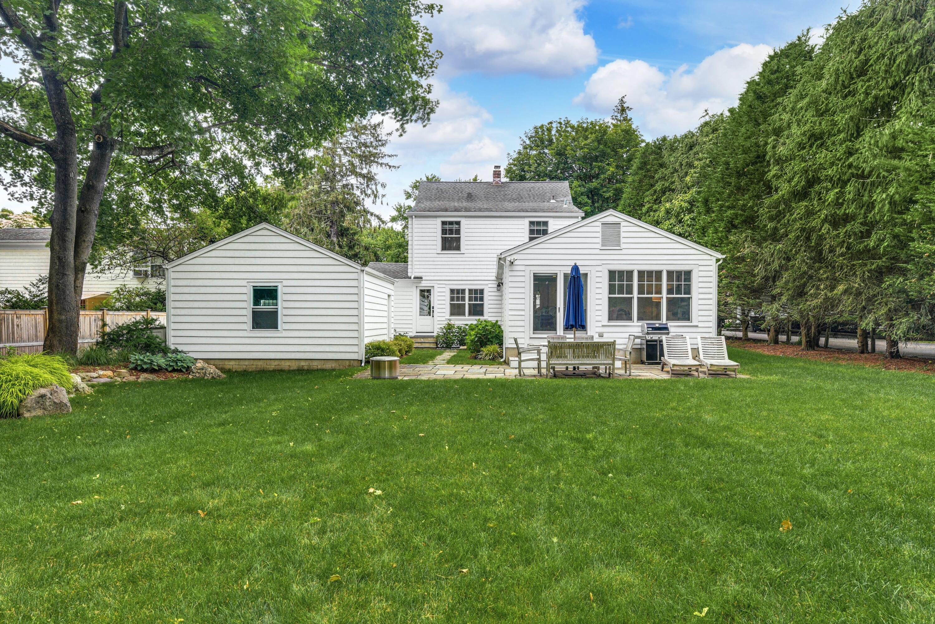 13 Sunset Road Darien, CT 06820 - Photo 25 of 28 a front view of a house with a yard table and chairs