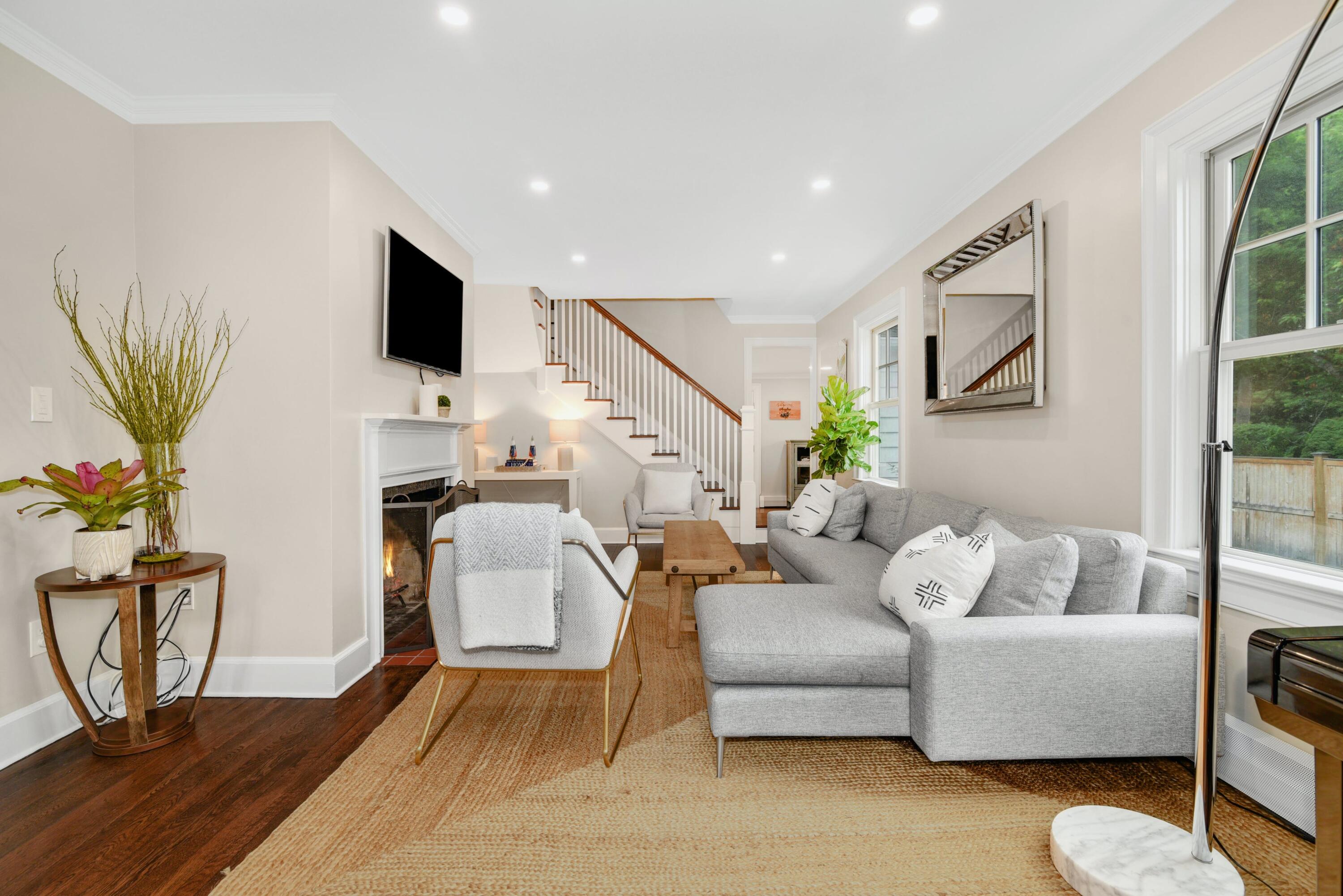 13 Sunset Road Darien, CT 06820 - Photo 3 of 28 a living room with furniture a flat screen tv and a potted plant