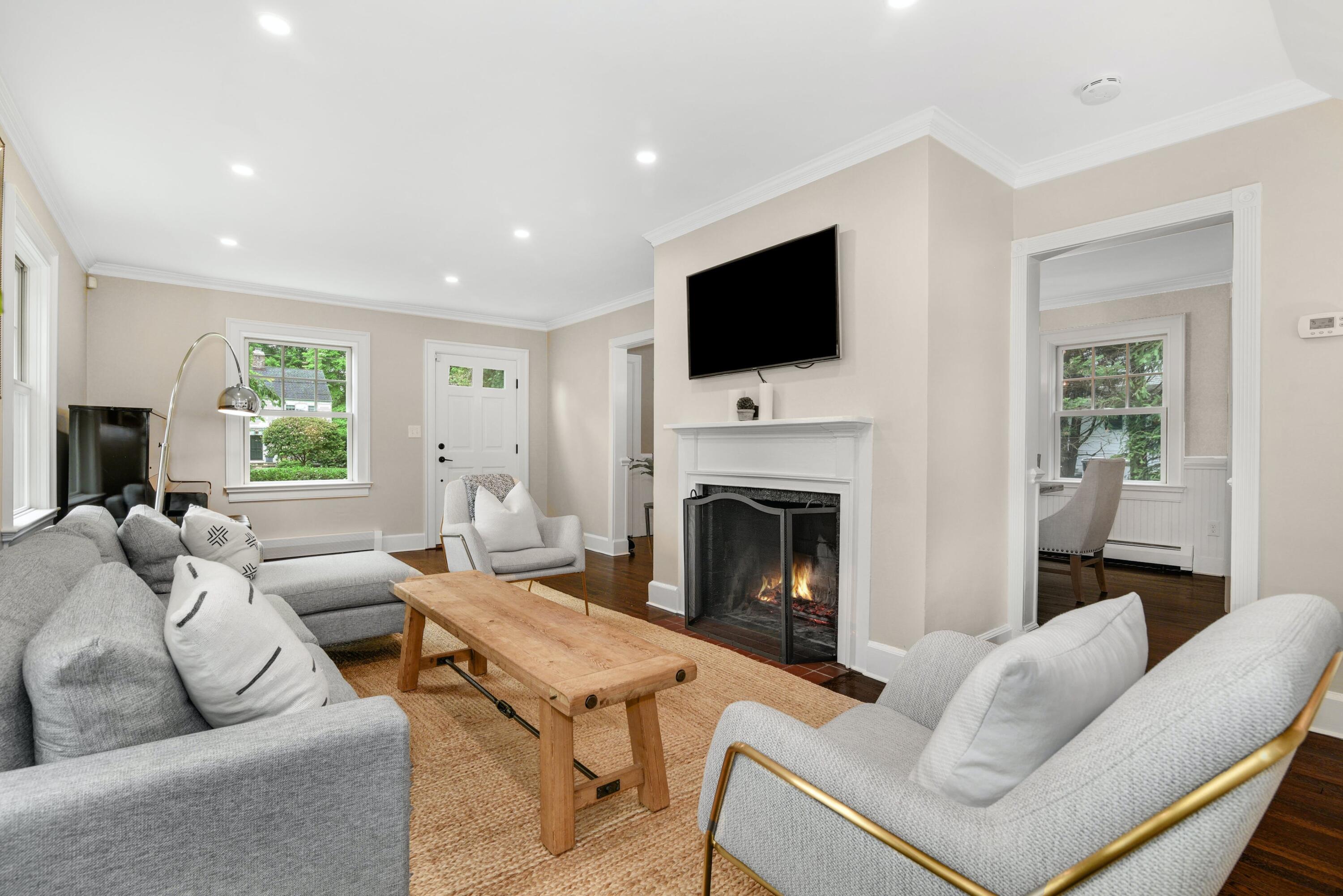 13 Sunset Road Darien, CT 06820 - Photo 4 of 28 a living room with furniture a fireplace and a flat screen tv