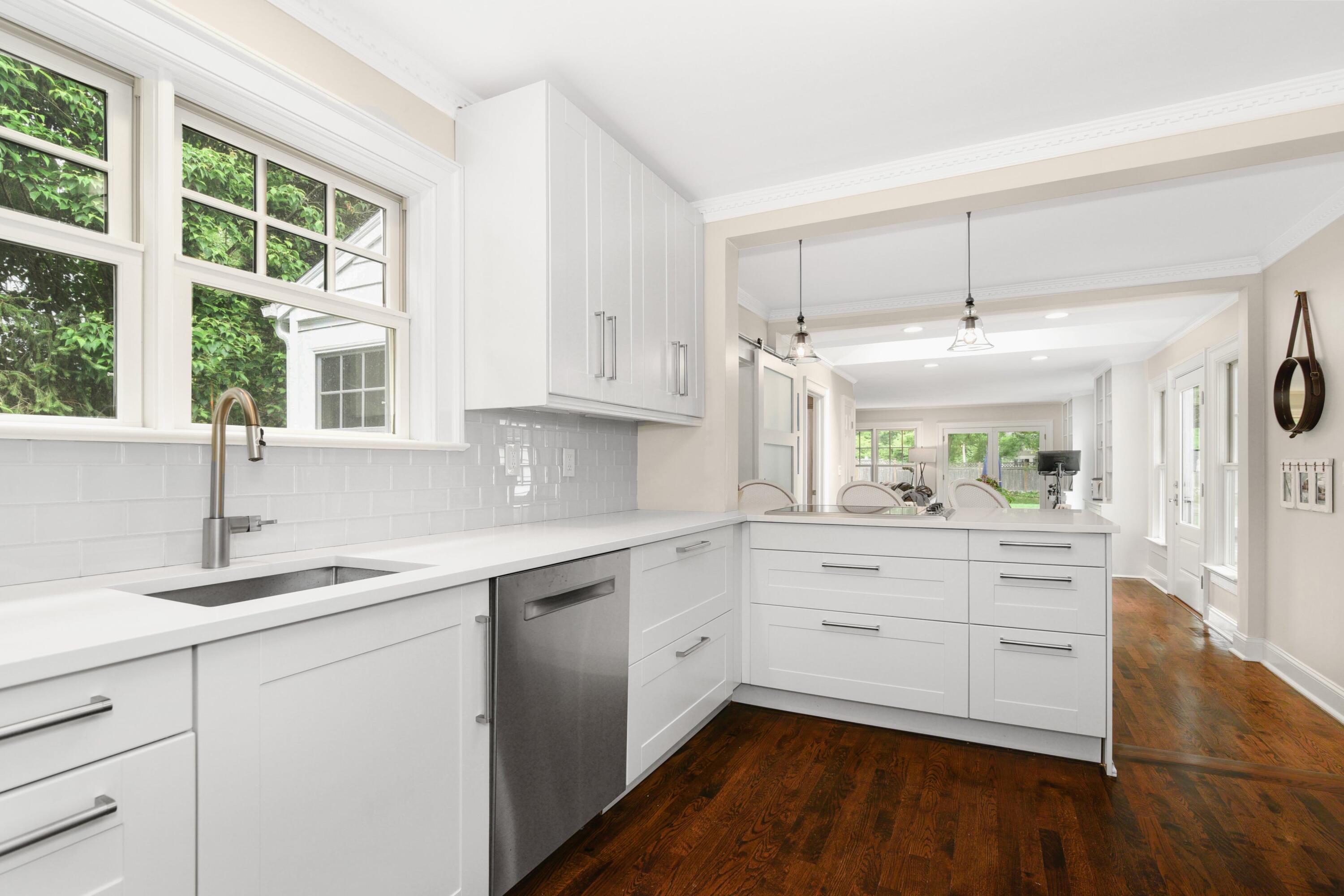 13 Sunset Road Darien, CT 06820 - Photo 6 of 28 a kitchen with white cabinets and a window