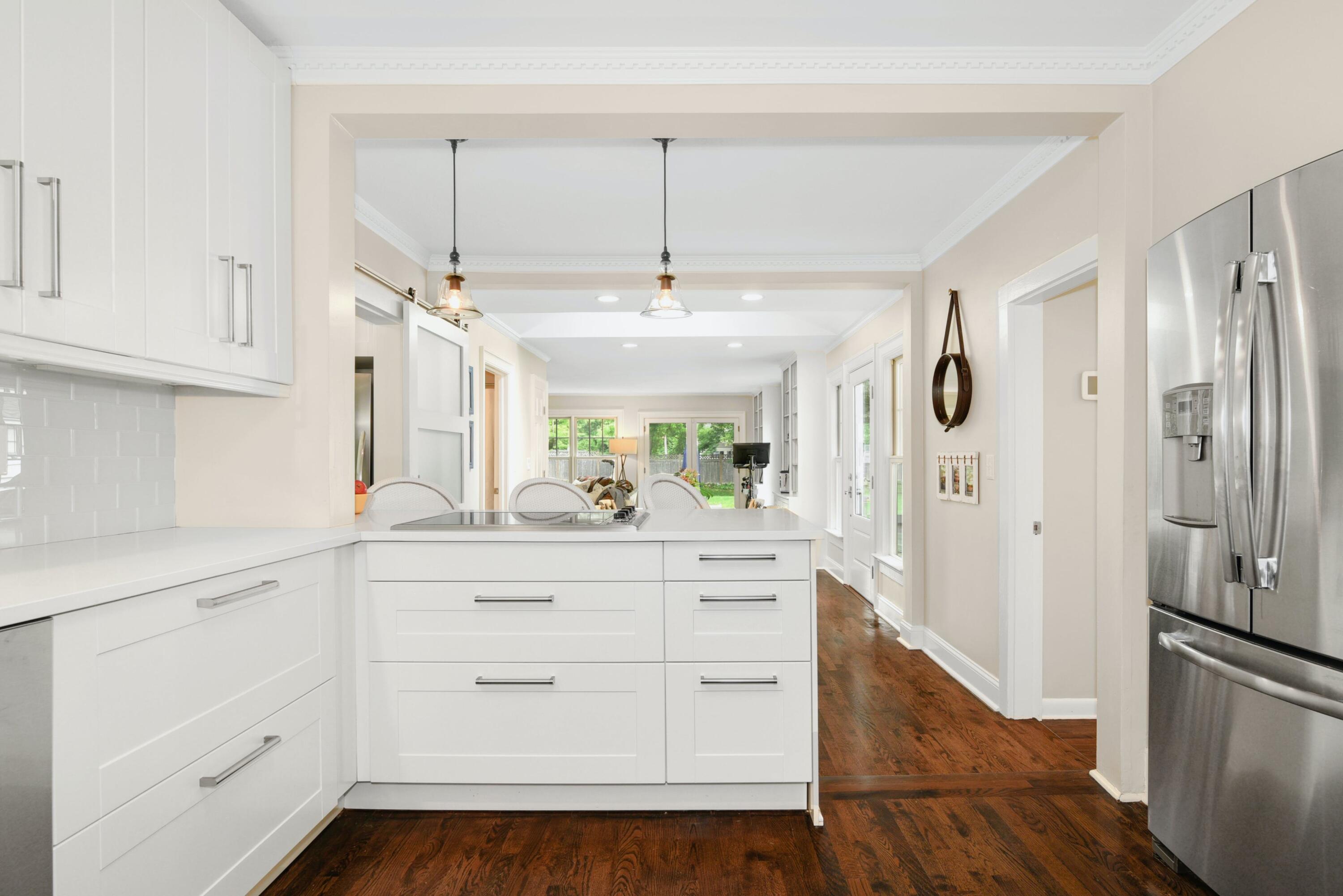 13 Sunset Road Darien, CT 06820 - Photo 7 of 28 a kitchen with white cabinets and stainless steel appliances