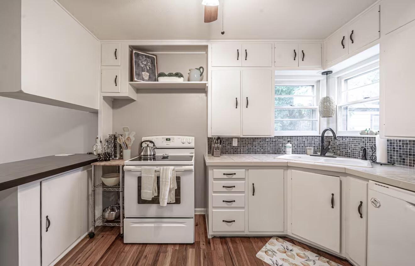2816 37th Street Lubbock, TX 79413 - Photo 11 of 19 a kitchen with a stove a sink and a refrigerator