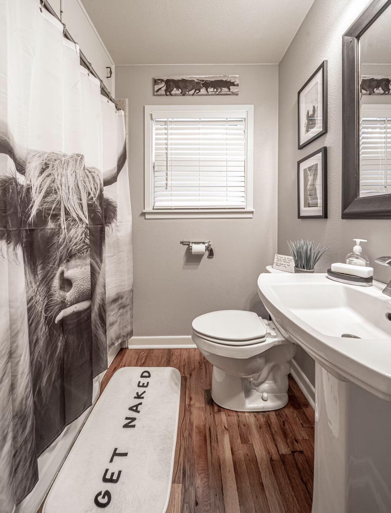 2816 37th Street Lubbock, TX 79413 - Photo 15 of 19 a bathroom with a toilet a sink and a mirror