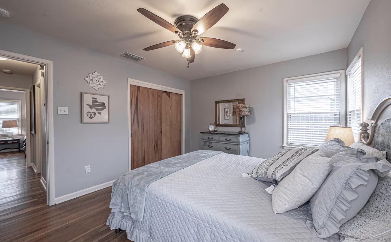 2816 37th Street Lubbock, TX 79413 - Photo 18 of 19 a bedroom with a large bed and a chandelier