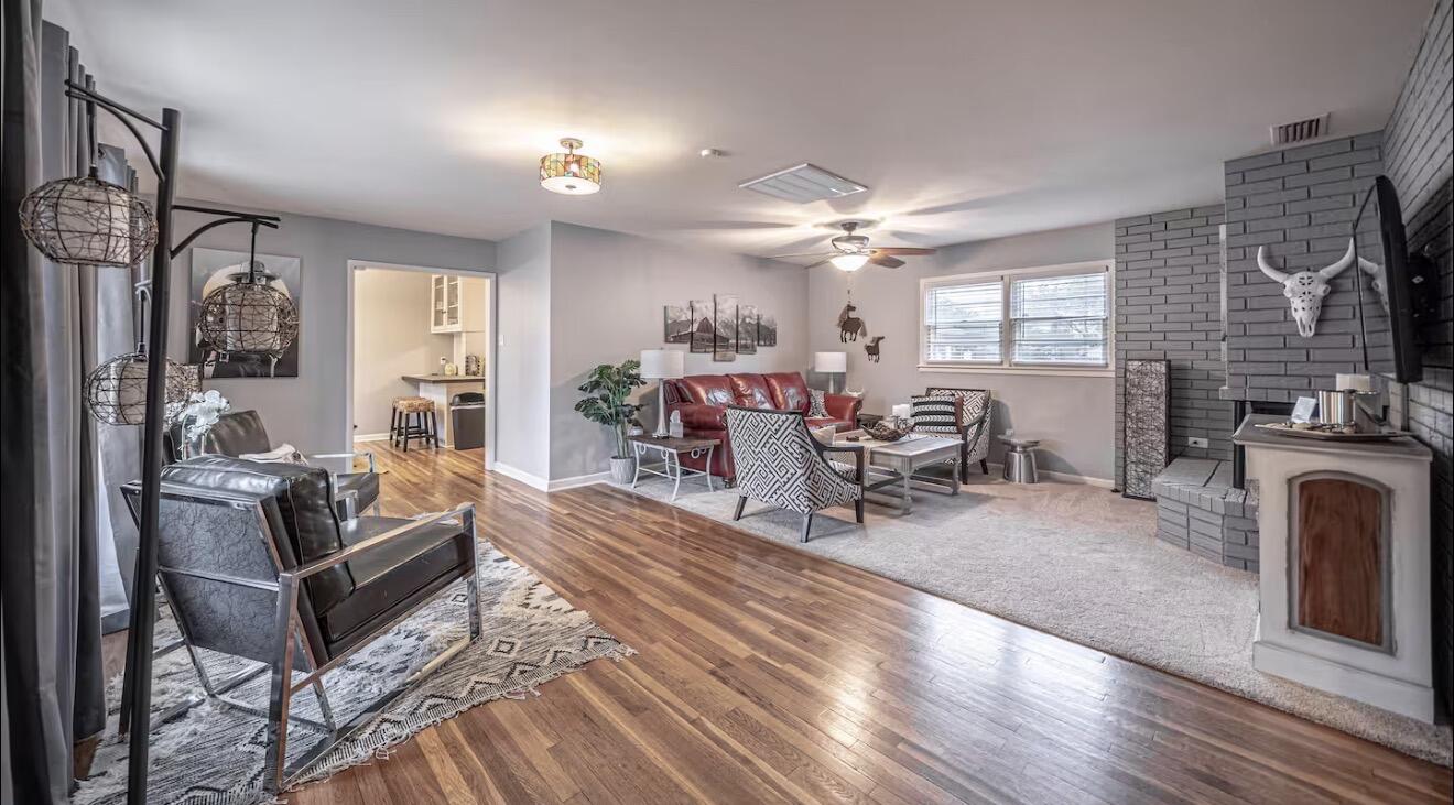 2816 37th Street Lubbock, TX 79413 - Photo 7 of 19 a living room with furniture a fireplace and a flat screen tv