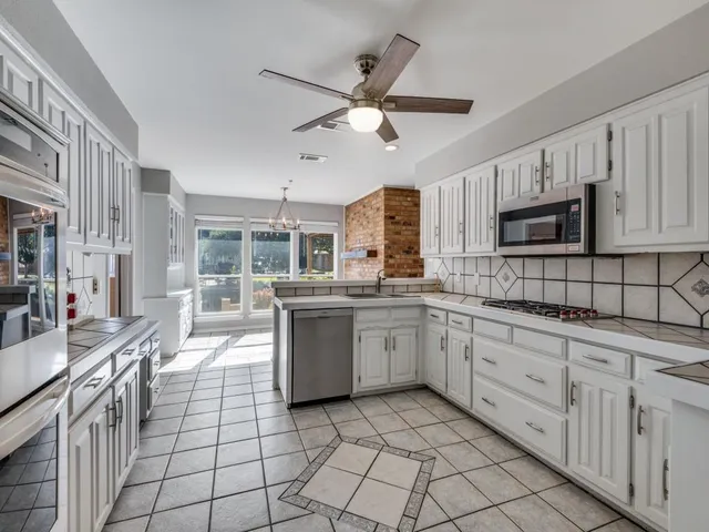 a view of a dining room with furniture large windows and wooden floor