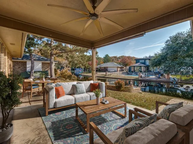 a view of a patio with table and chairs with wooden floor and fence
