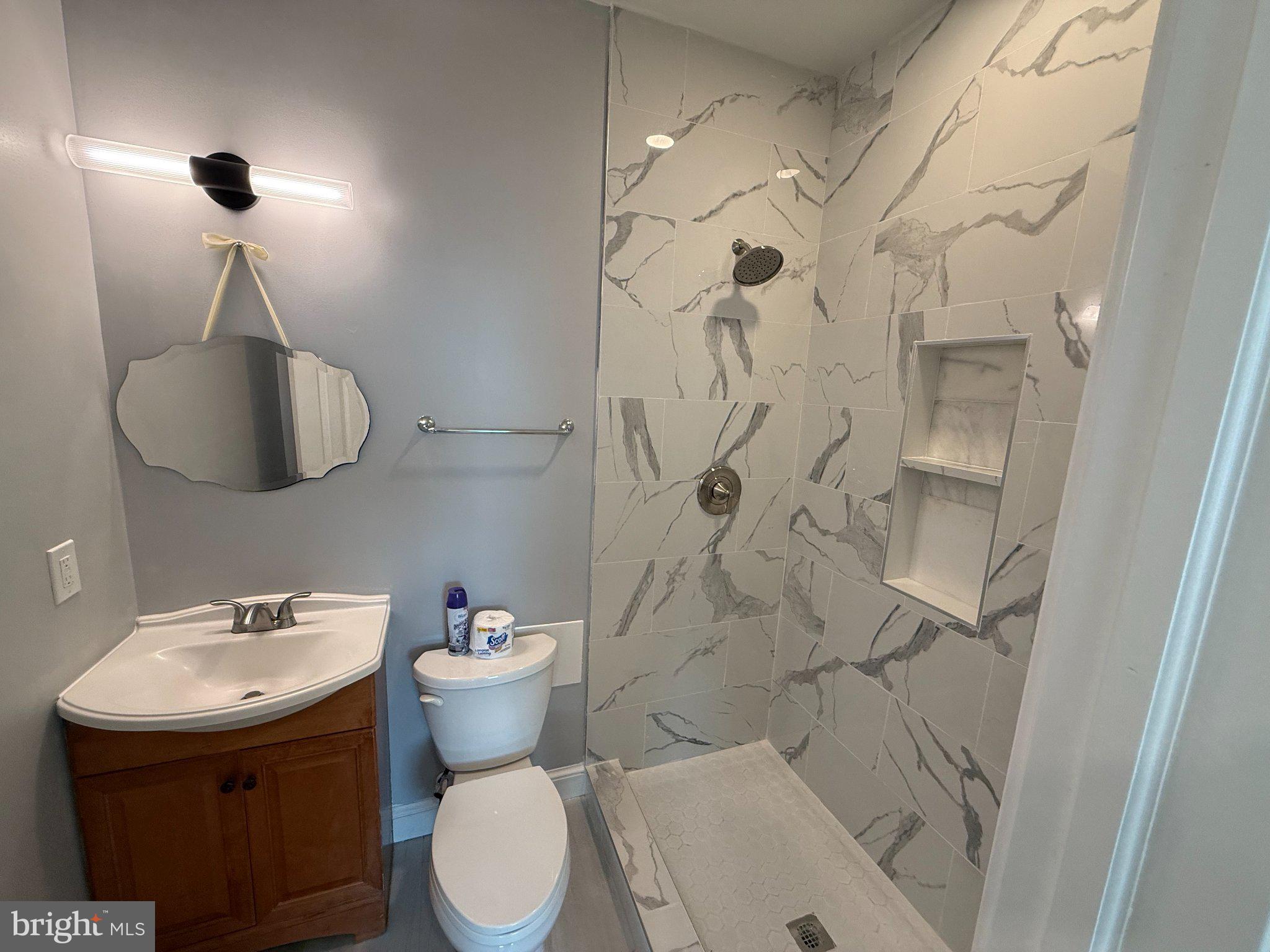 1930 North Payson Street Baltimore, MD 21217 - Photo 5 of 12 a bathroom with a sink toilet and shower