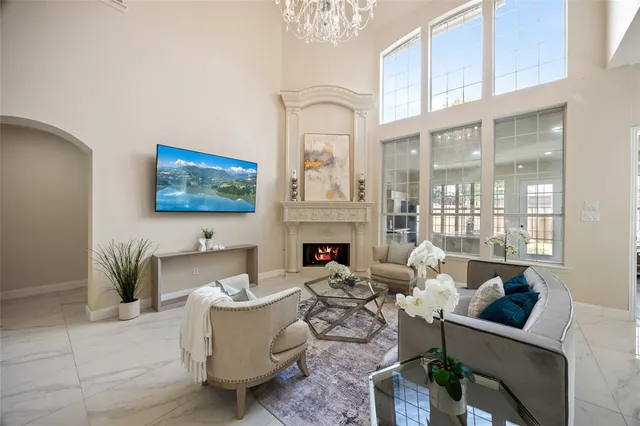 a living room with furniture a fireplace and a flat screen tv