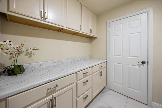 a view of a kitchen with white cabinets