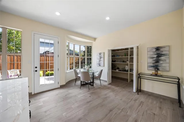 a living room with furniture and large windows