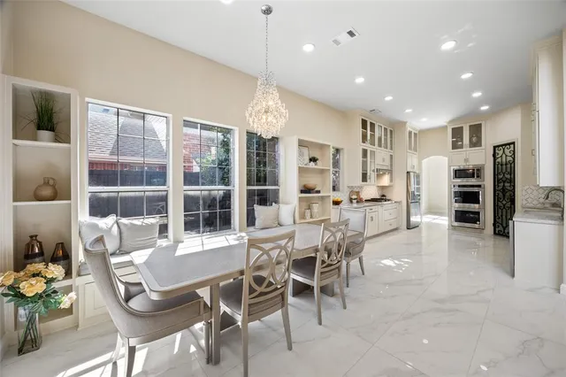 a dining room with furniture and a floor to ceiling window