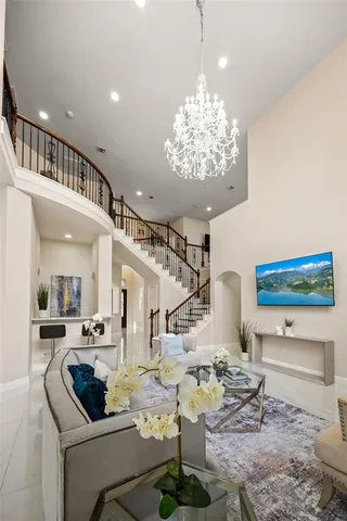 a living room with furniture and a chandelier