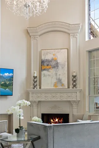 a room with a fireplace and a painting on the wall