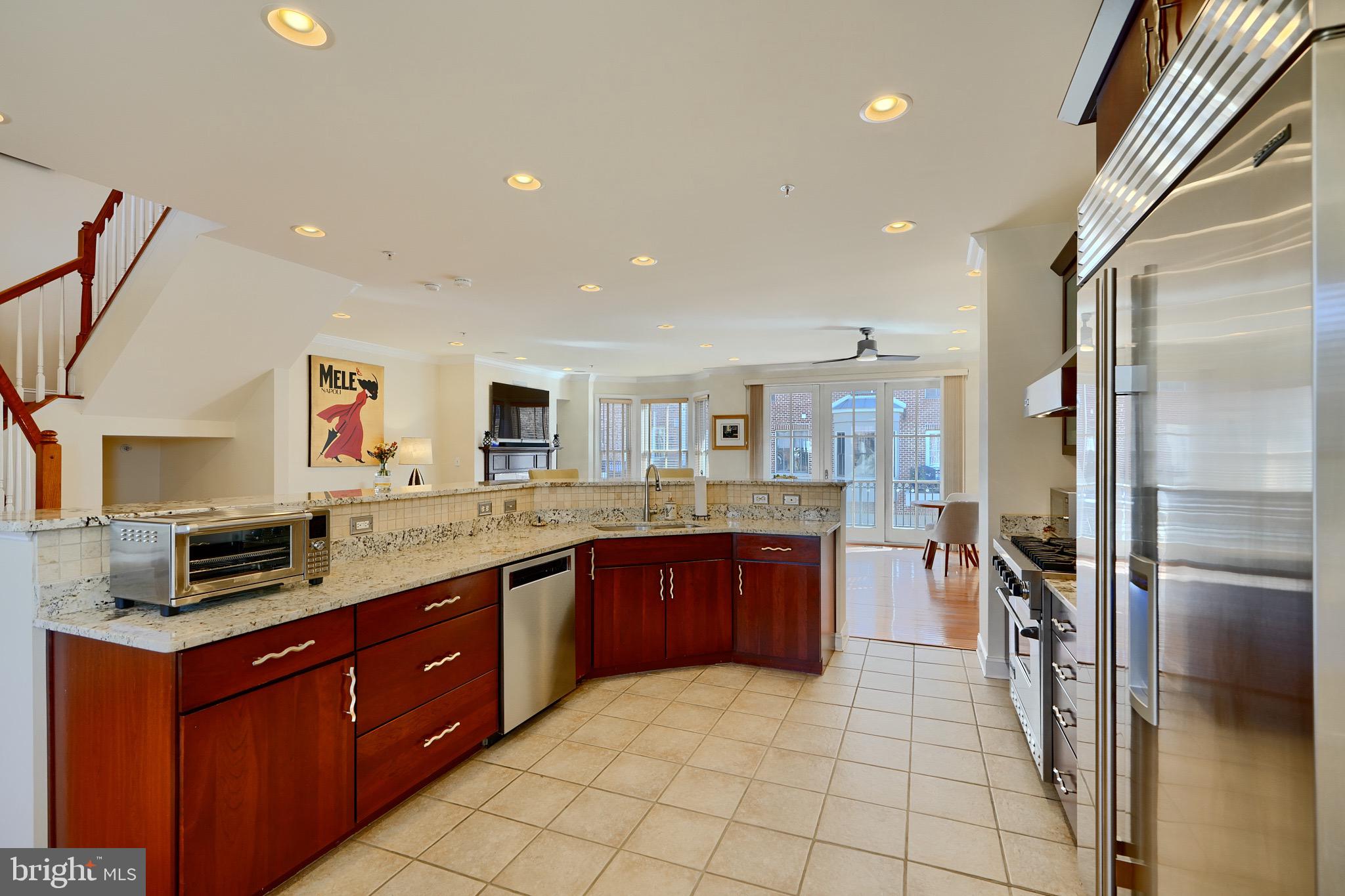 1221 Dockside Circle Baltimore, MD 21224 - Photo 11 of 57 a kitchen with stainless steel appliances granite countertop a sink counter space cabinets and a large window