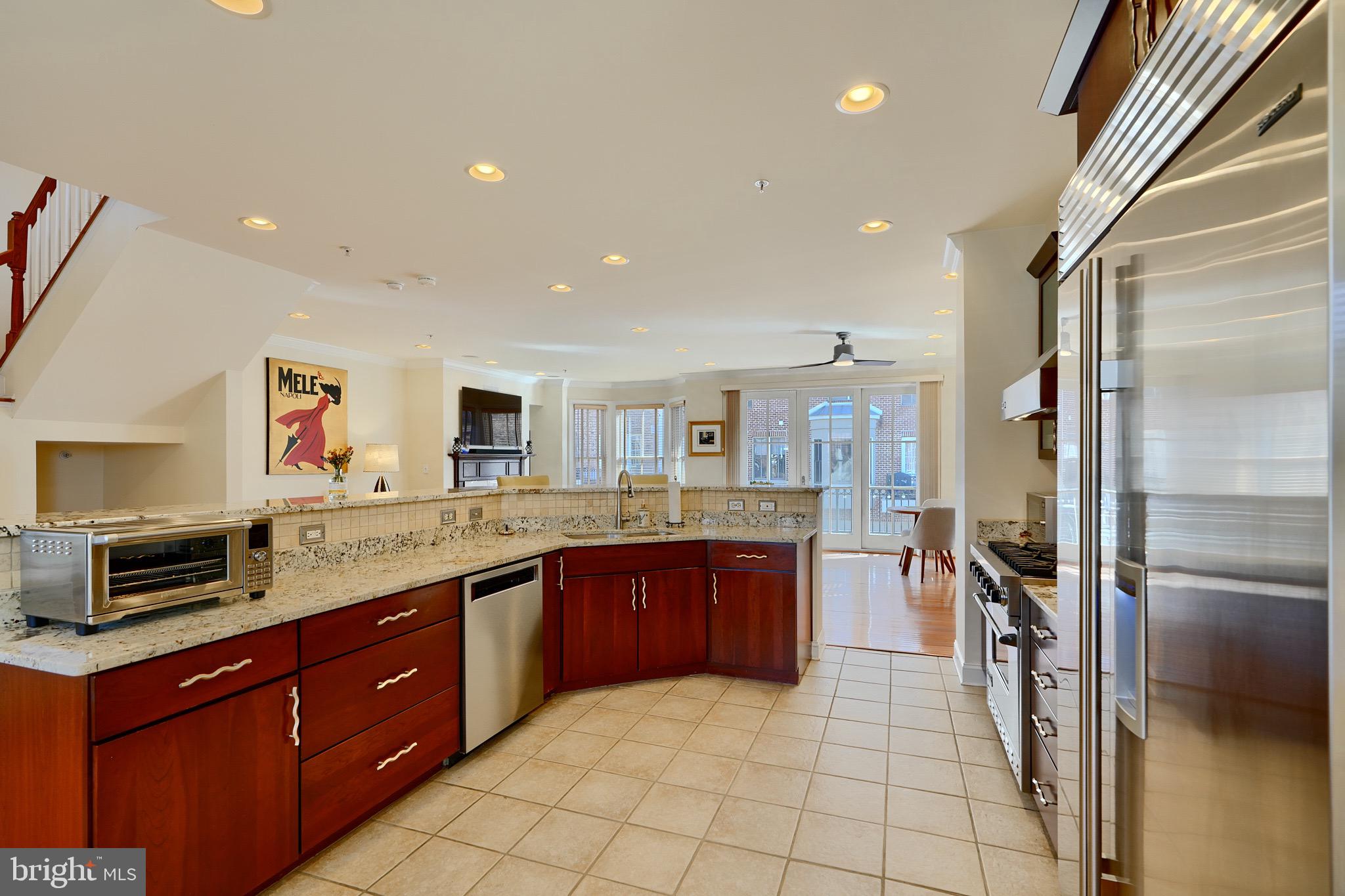 1221 Dockside Circle Baltimore, MD 21224 - Photo 13 of 57 a large kitchen with stainless steel appliances granite countertop a refrigerator and a sink