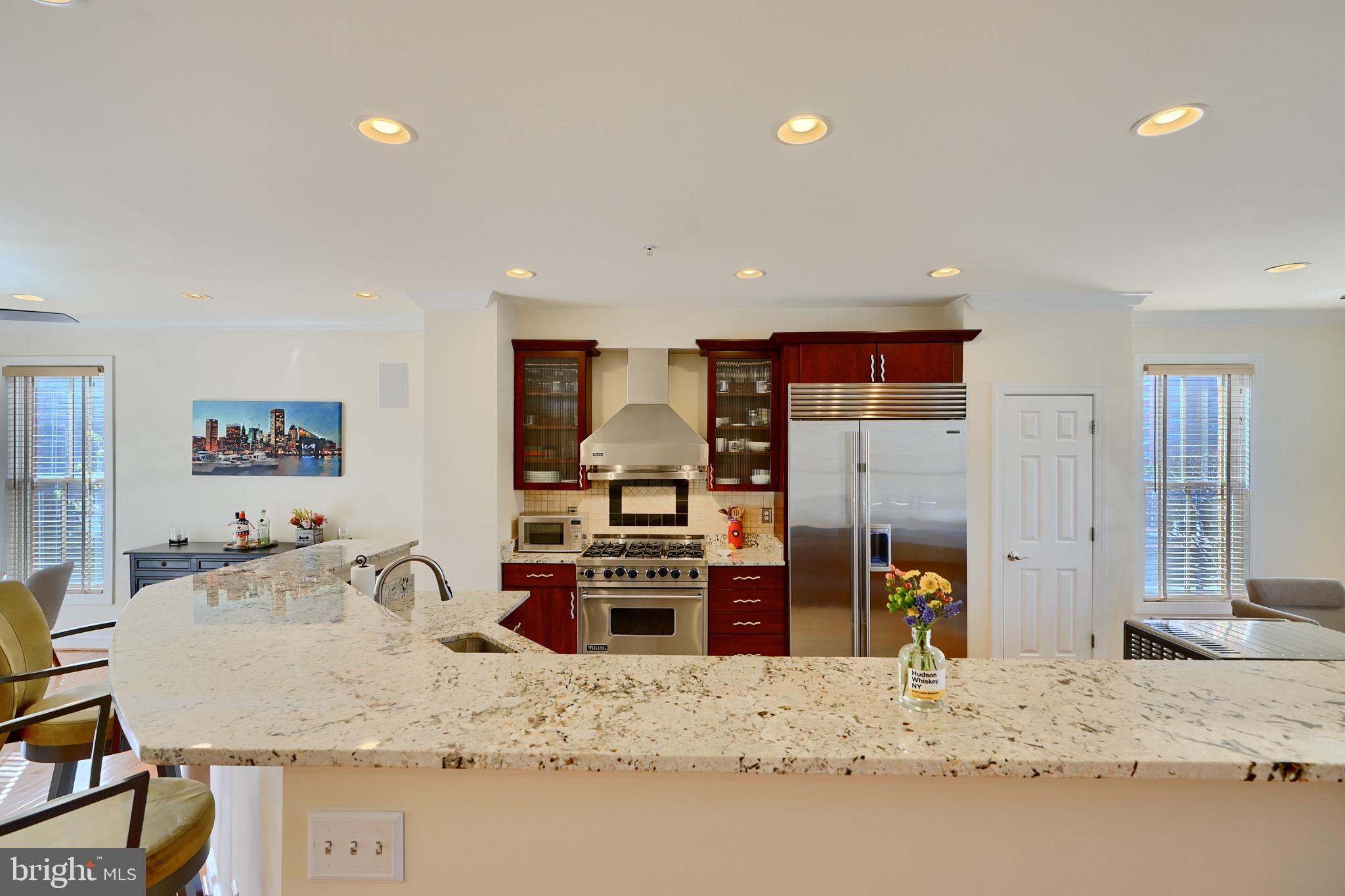 1221 Dockside Circle Baltimore, MD 21224 - Photo 15 of 57 a view of a kitchen with granite countertop a sink and a refrigerator