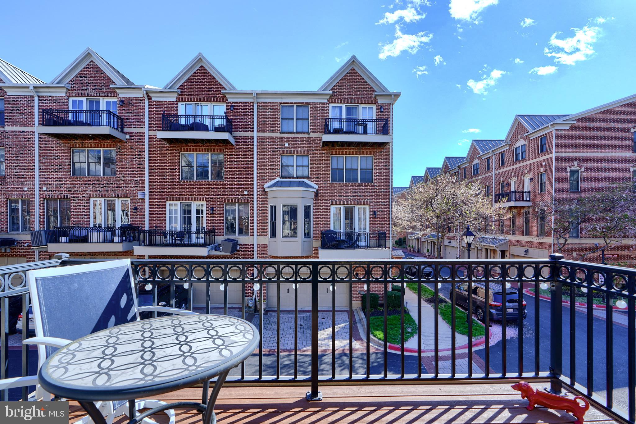 1221 Dockside Circle Baltimore, MD 21224 - Photo 24 of 57 a view of a brick house with wooden deck and furniture