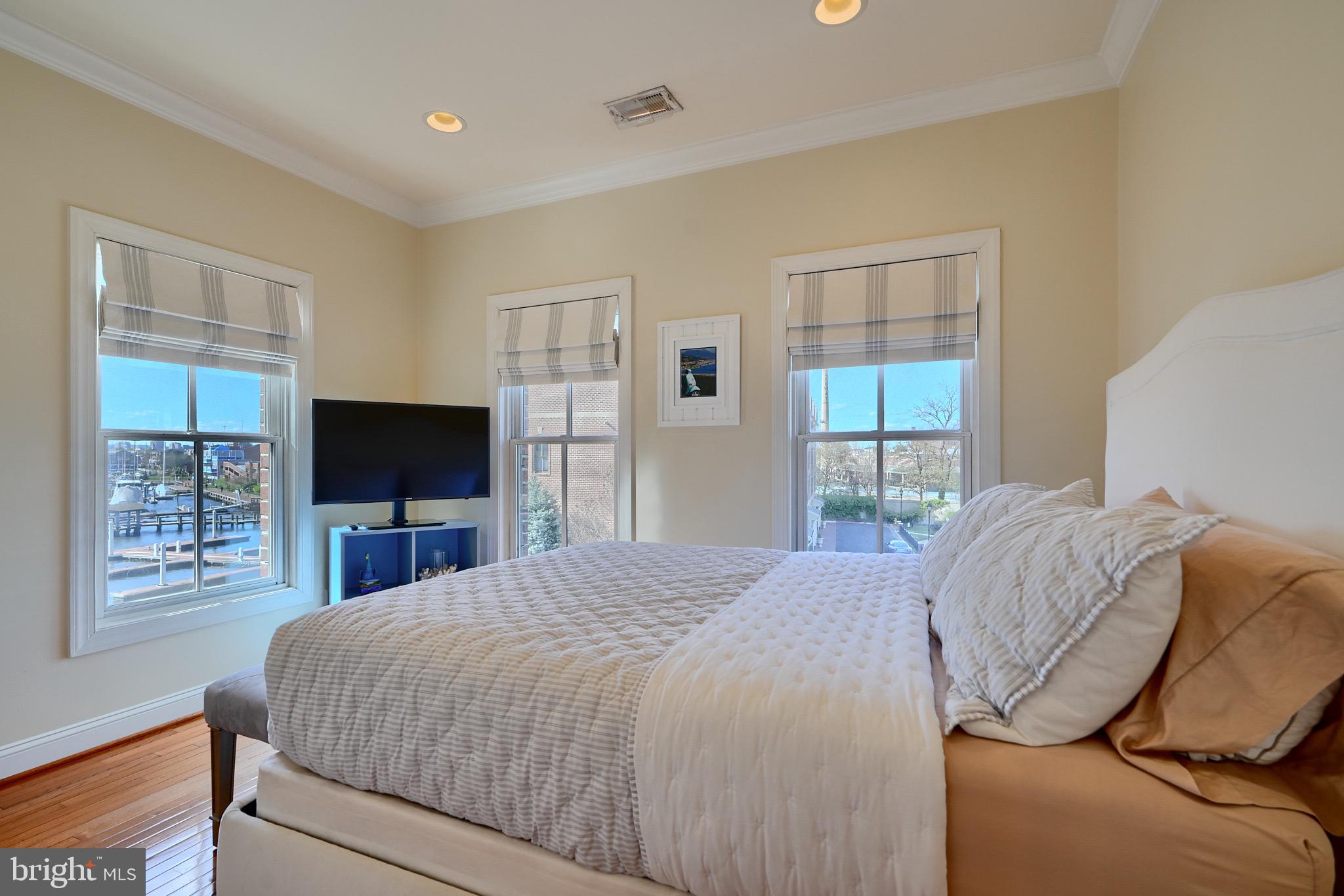 1221 Dockside Circle Baltimore, MD 21224 - Photo 35 of 57 a bedroom with a bed and a flat screen tv