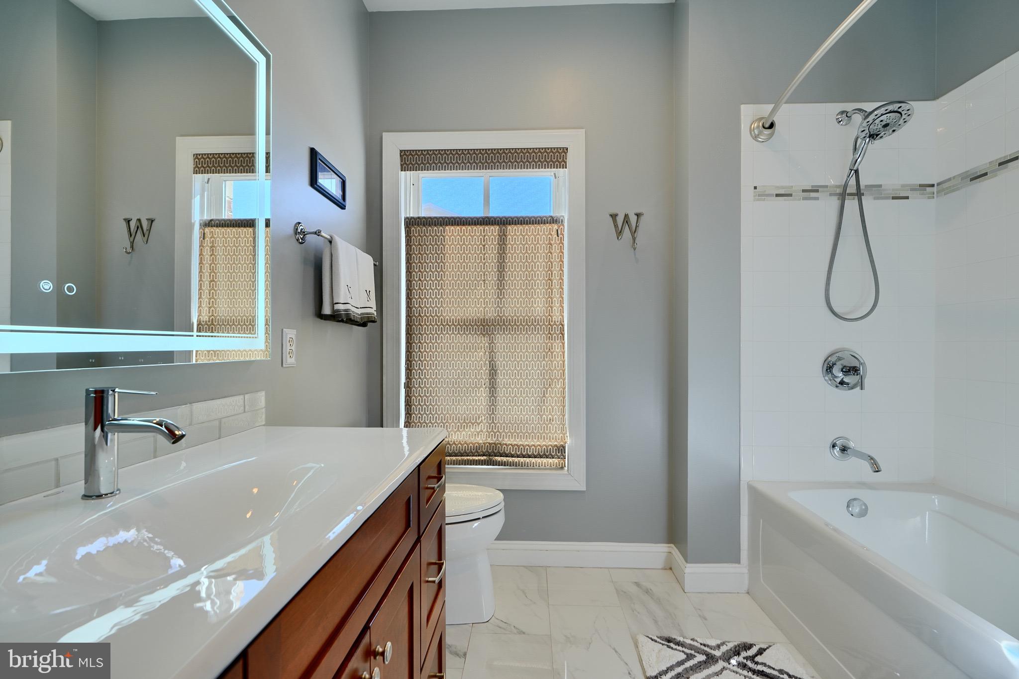 1221 Dockside Circle Baltimore, MD 21224 - Photo 37 of 57 a bathroom with a tub sink and mirror