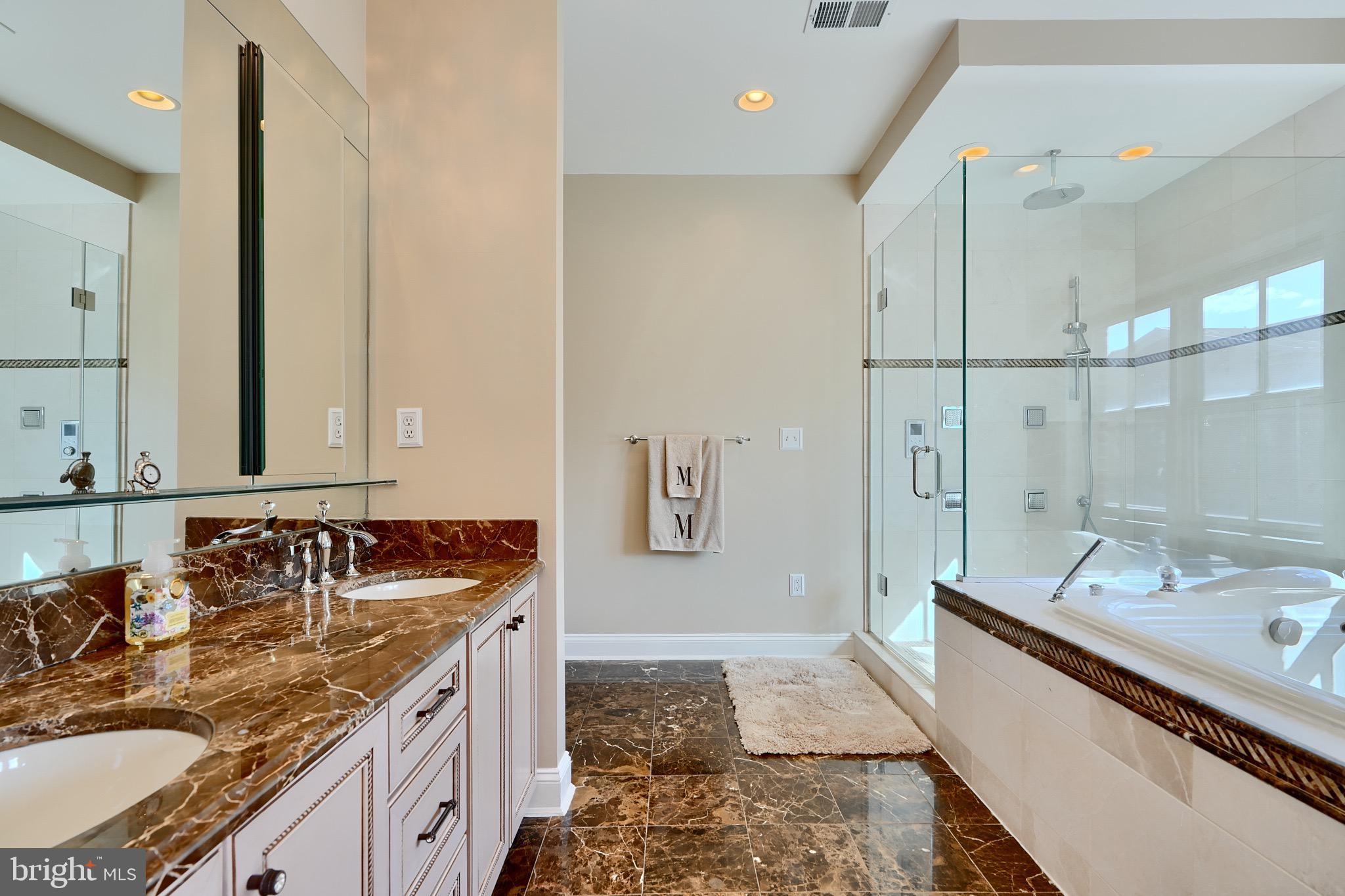1221 Dockside Circle Baltimore, MD 21224 - Photo 44 of 57 a bathroom with a granite countertop double vanity sink a mirror and shower