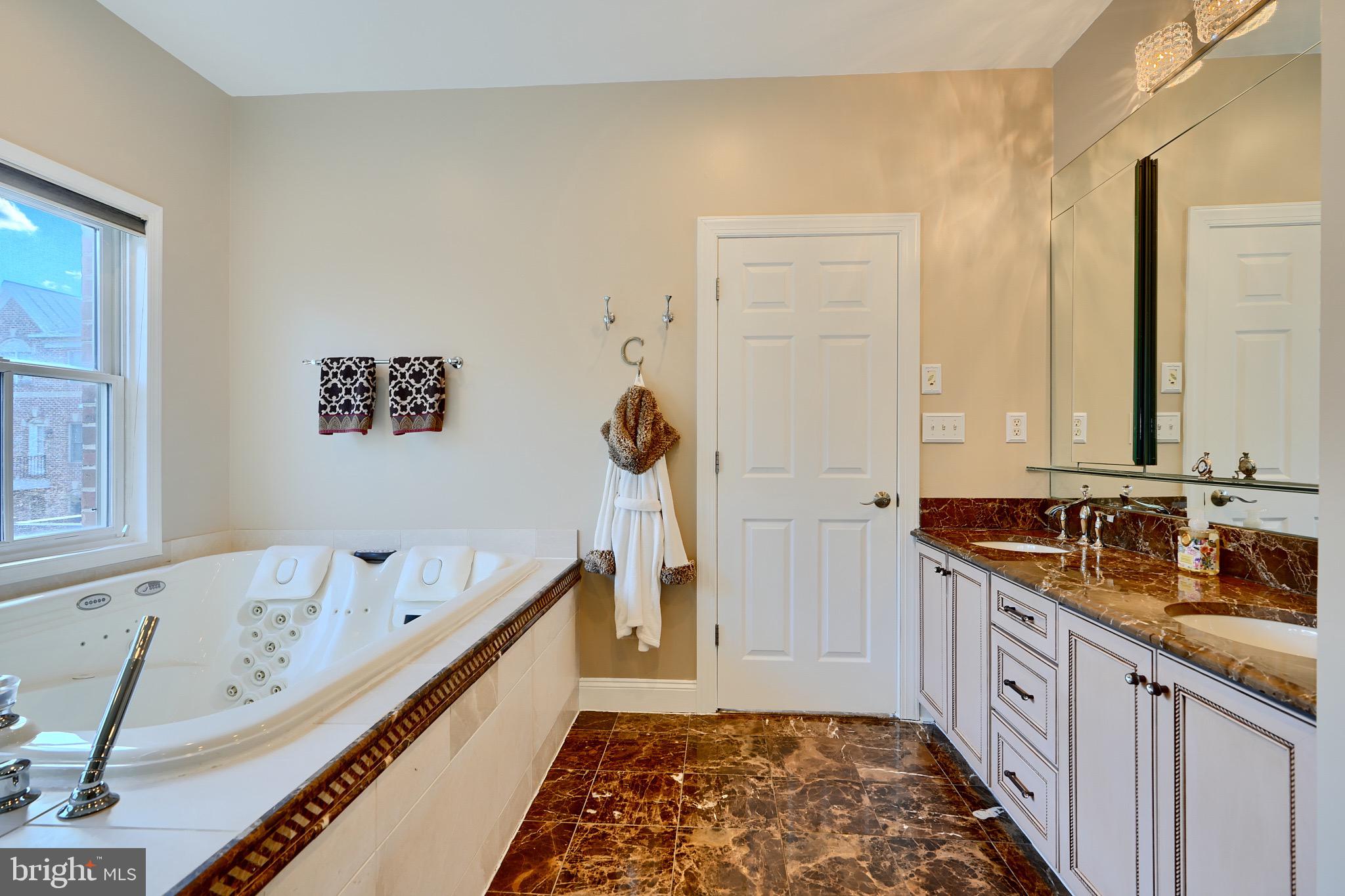 1221 Dockside Circle Baltimore, MD 21224 - Photo 47 of 57 a bathroom with a double vanity sink and a mirror