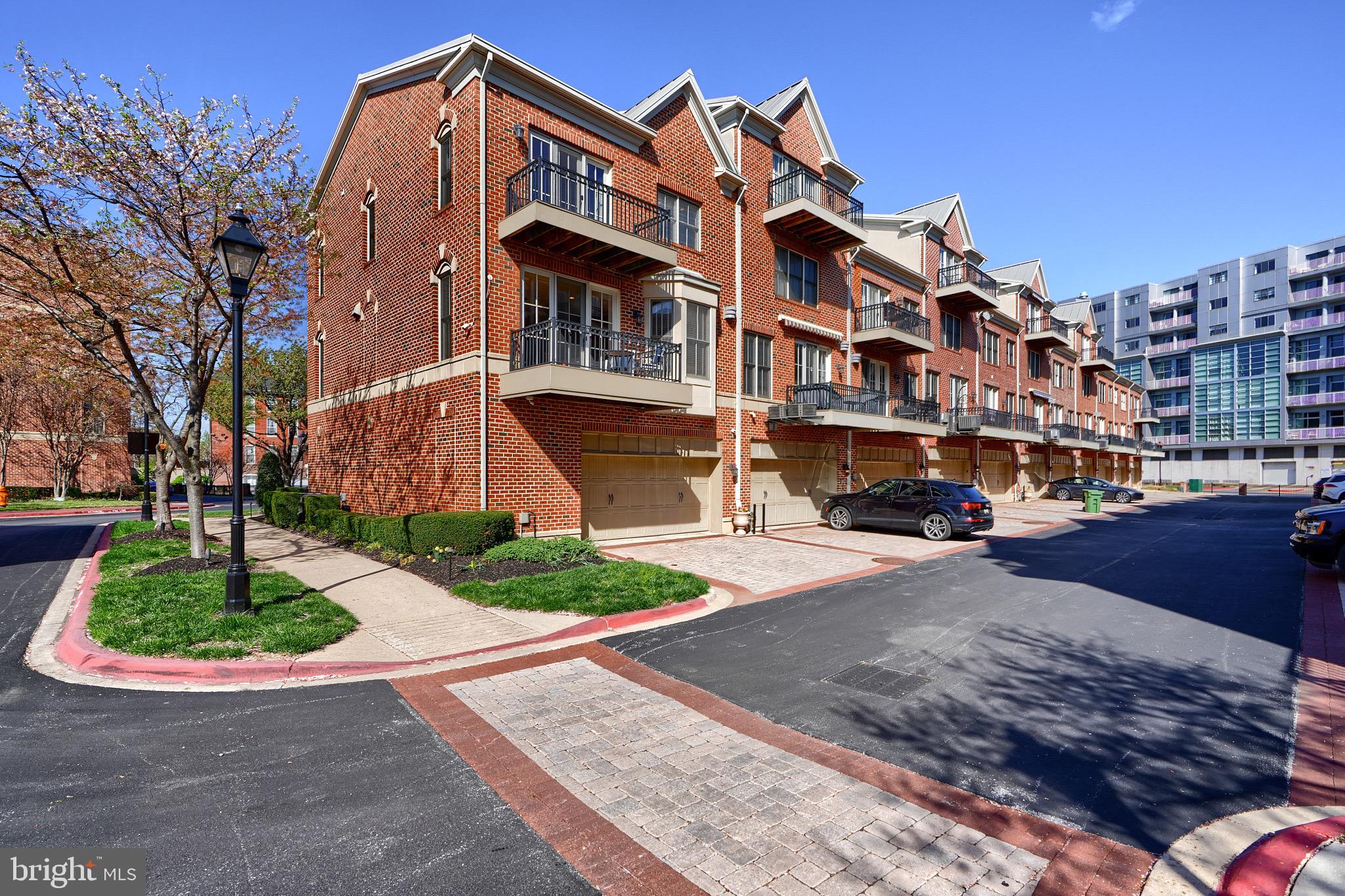 1221 Dockside Circle Baltimore, MD 21224 - Photo 55 of 57 a front view of a building with a garden and plants