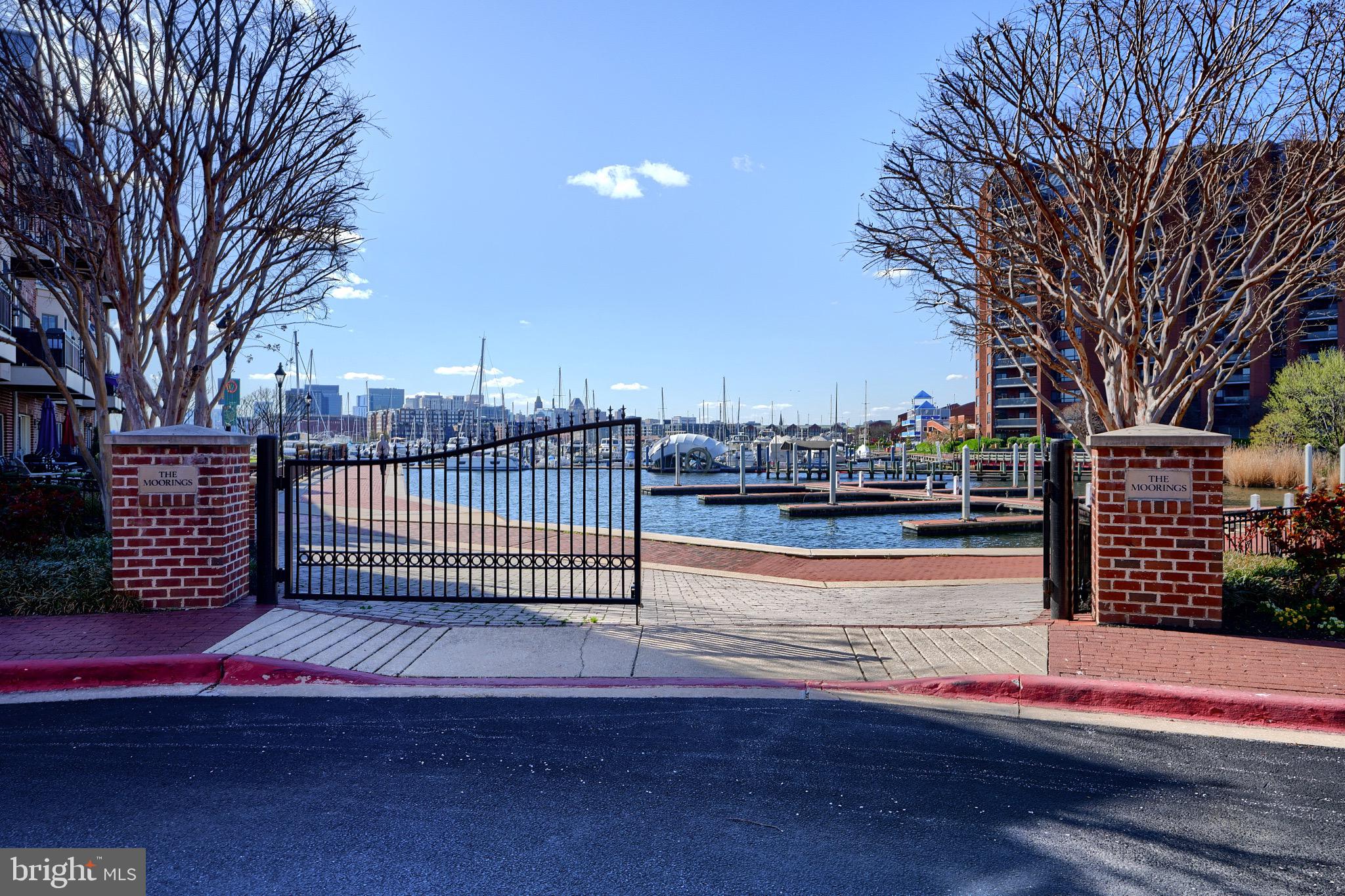 1221 Dockside Circle Baltimore, MD 21224 - Photo 57 of 57 a view of a street with a bench and wooden fence