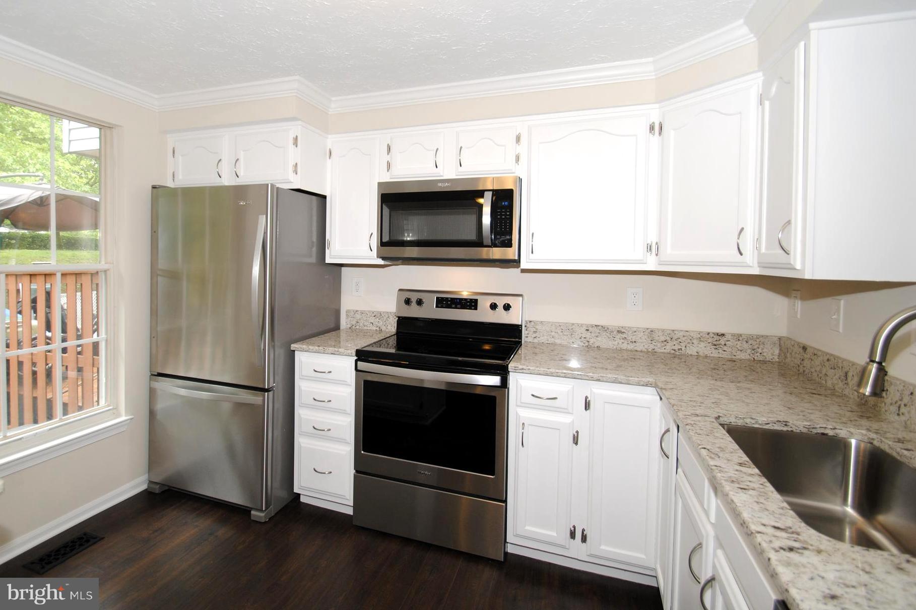 579 Quaker Ridge Court Arnold, MD 21012 - Photo 14 of 30 Sleek Granite Counters and Wood Cabinetry