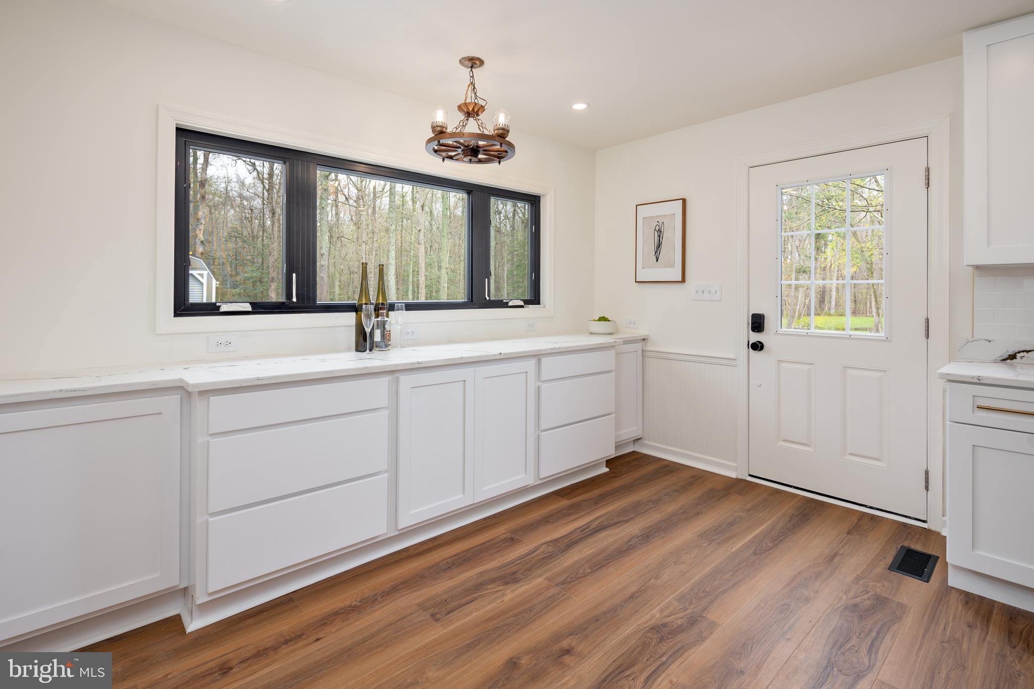 324 Flat Iron Square Road Church Hill, MD 21623 - Photo 13 of 47 a view of a big room with wooden floor and windows