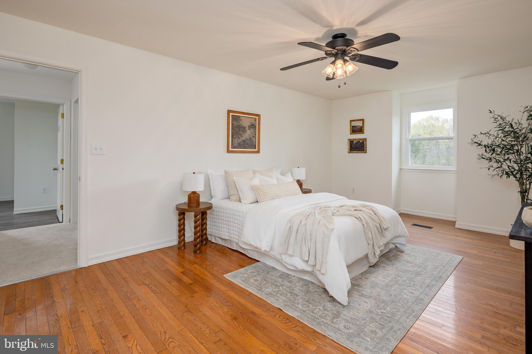 324 Flat Iron Square Road Church Hill, MD 21623 - Photo 24 of 47 a bed room with a bed and a chandelier