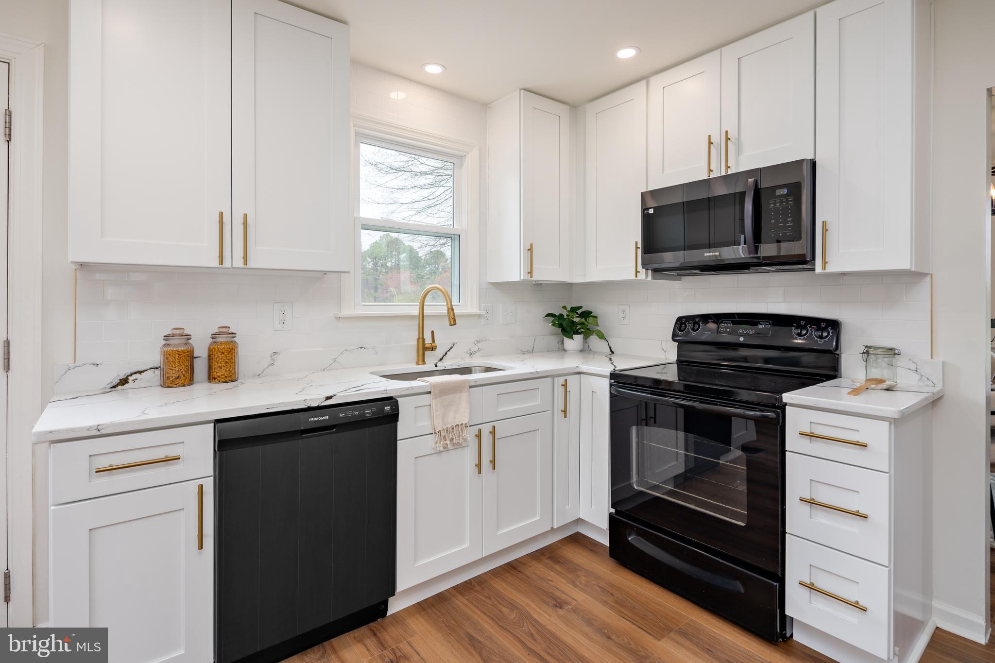 324 Flat Iron Square Road Church Hill, MD 21623 - Photo 9 of 47 a kitchen with cabinets stainless steel appliances a sink and a microwave